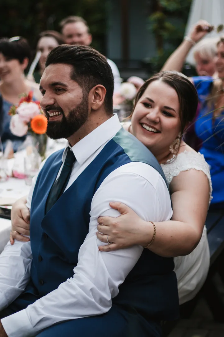Bernhard and Lisa laughing together at their wedding.