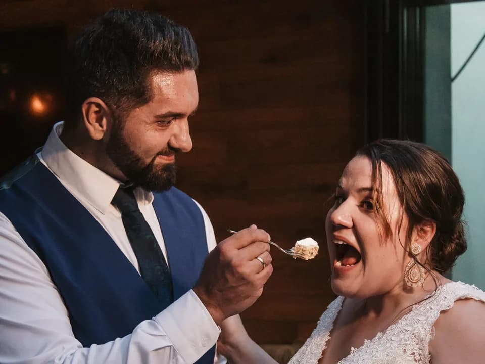 Bernhard feeding Lisa the first bite of wedding cake.